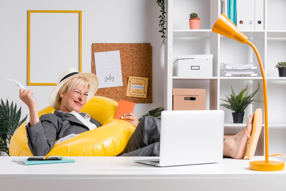 Woman relaxing on yellow chair in modern home office with shelving, desk lamp, and plants