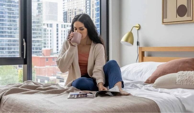 Woman providing guest support services via phone call in modern apartment for vacation rental management
